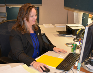 Photo of Robin Sylvester at her desk.